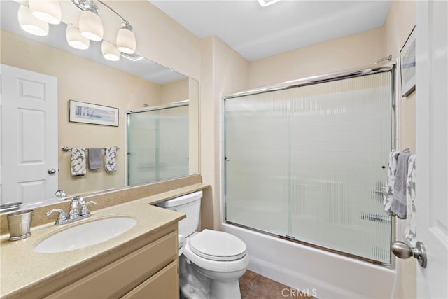 full bath featuring tile patterned floors, combined bath / shower with glass door, toilet, and vanity