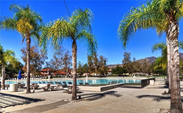 view of swimming pool with a mountain view