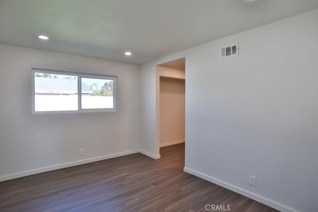 empty room featuring dark hardwood / wood-style flooring