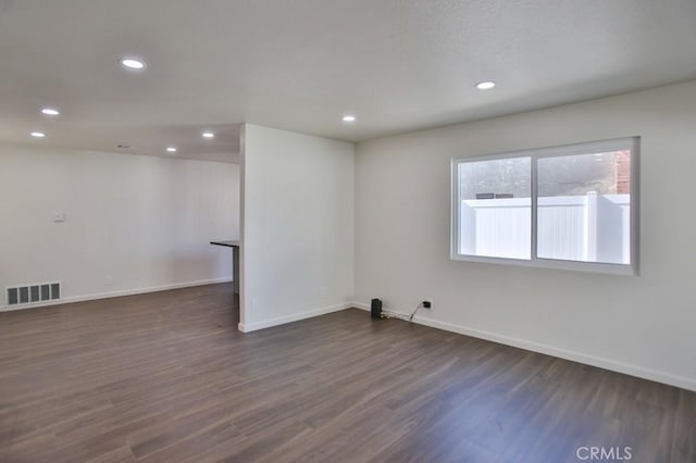 unfurnished room with dark hardwood / wood-style floors