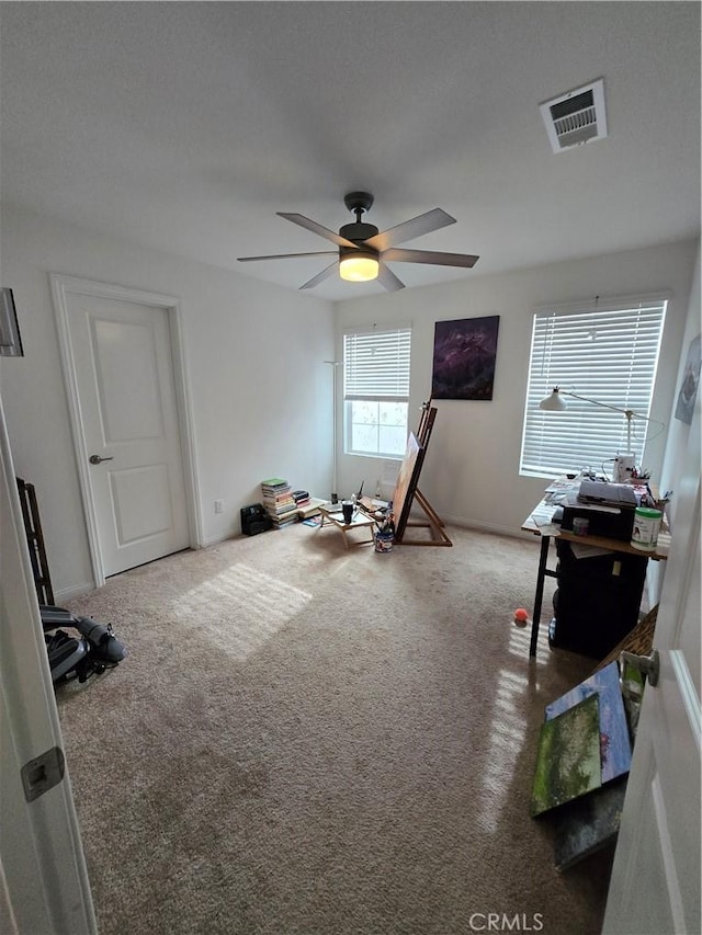 miscellaneous room with ceiling fan, carpet floors, and a textured ceiling