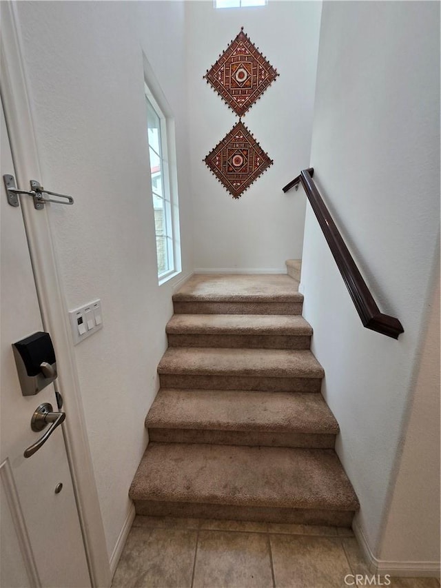 staircase featuring tile patterned floors