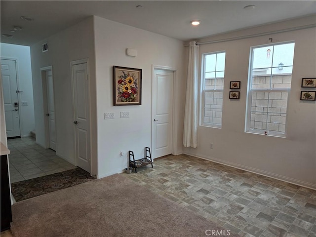 spare room with light colored carpet