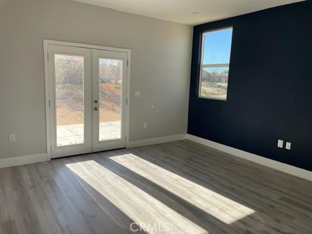 unfurnished room featuring french doors and wood-type flooring