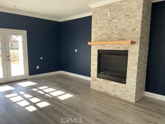 unfurnished living room featuring french doors, ornamental molding, and hardwood / wood-style floors