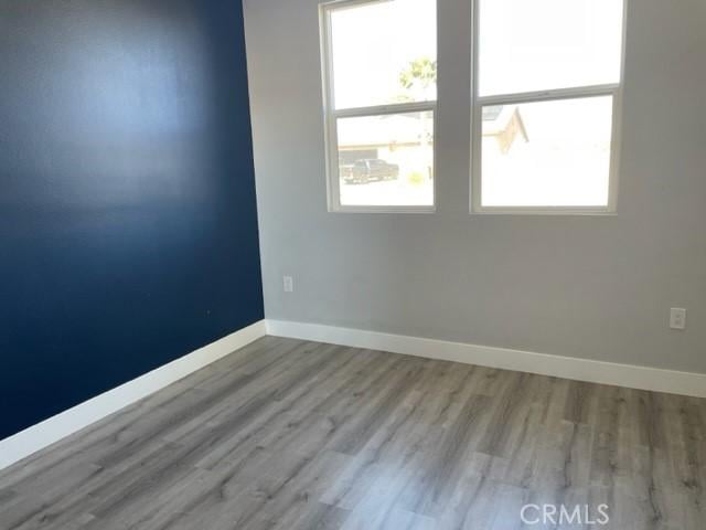 spare room with light hardwood / wood-style flooring