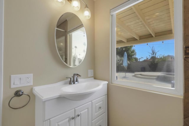 bathroom featuring beamed ceiling, vanity, and wooden ceiling