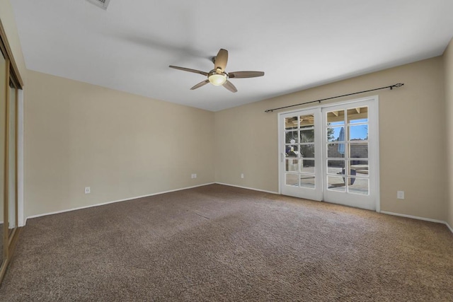 carpeted empty room featuring french doors and ceiling fan