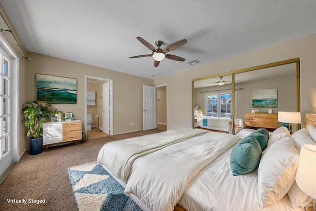 carpeted bedroom featuring connected bathroom, a closet, and ceiling fan