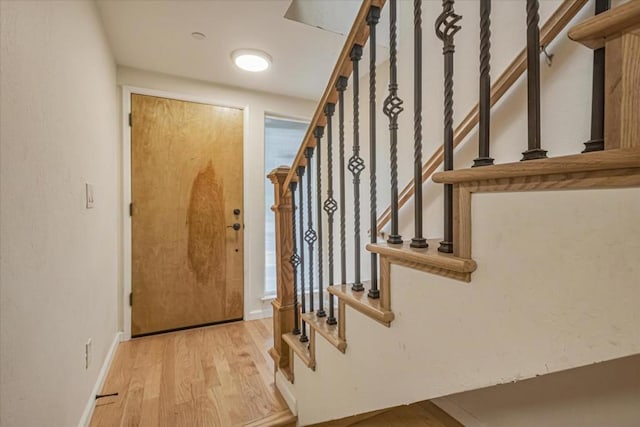 stairs with hardwood / wood-style flooring