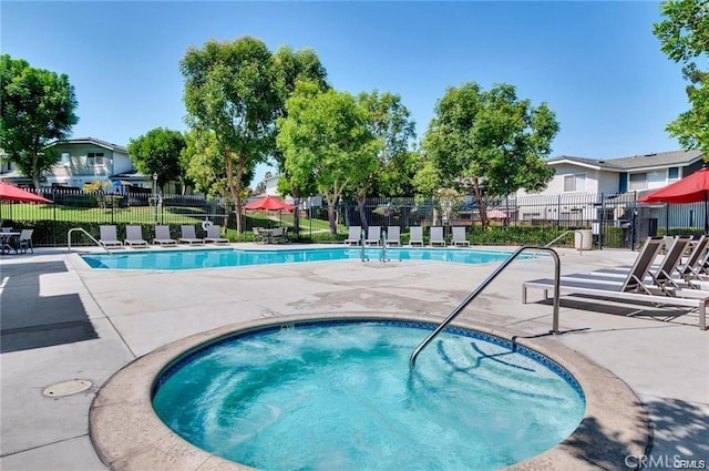 view of swimming pool featuring a community hot tub and a patio area