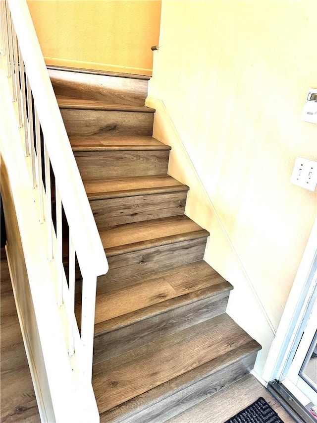 stairway featuring hardwood / wood-style flooring