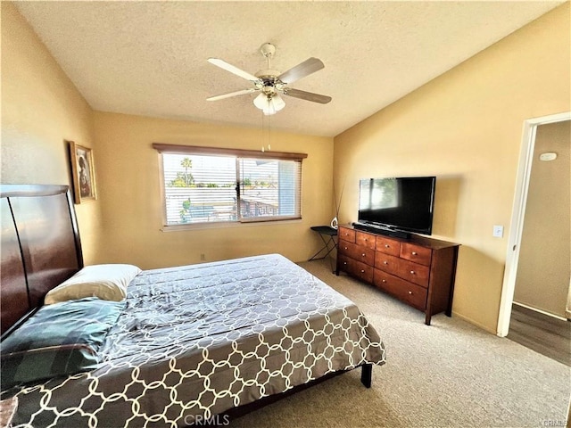 carpeted bedroom featuring ceiling fan, lofted ceiling, and a textured ceiling