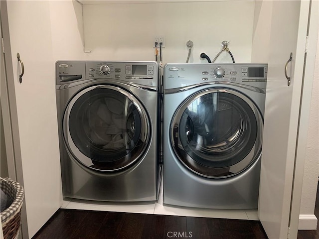 washroom featuring hardwood / wood-style flooring and washer and dryer