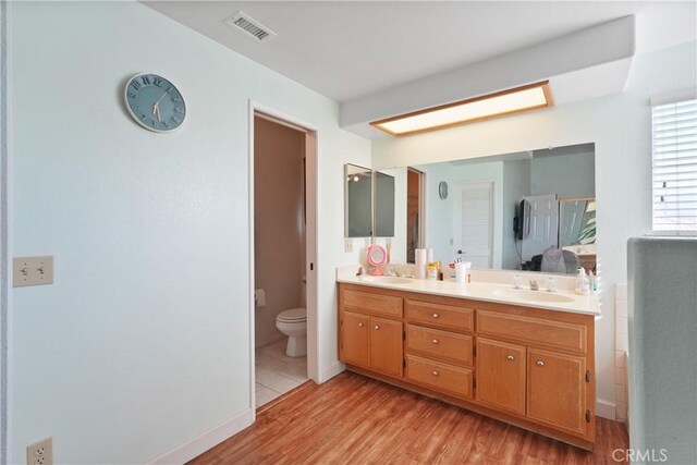 bathroom featuring vanity, toilet, and wood-type flooring