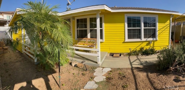 view of home's exterior with fence