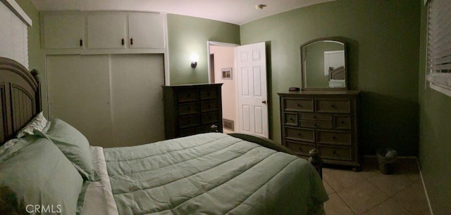 bedroom featuring tile patterned flooring and a closet