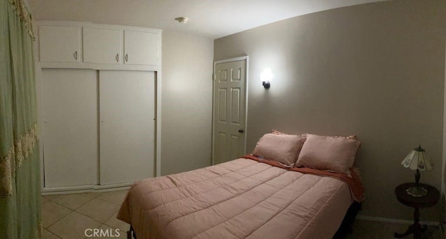 tiled bedroom featuring a closet