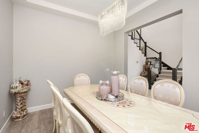 dining room with a chandelier and hardwood / wood-style flooring