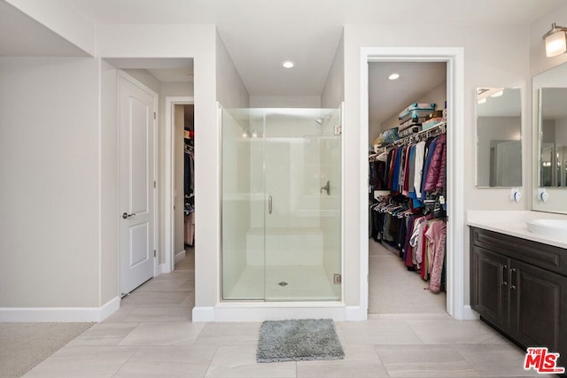 bathroom featuring vanity and an enclosed shower