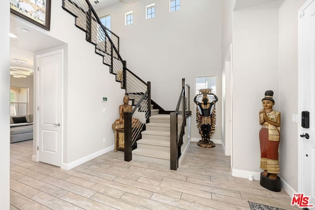 foyer featuring a high ceiling and light wood-type flooring