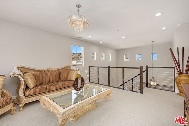 carpeted living room featuring a chandelier