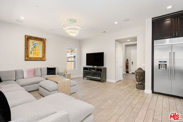 living room featuring light hardwood / wood-style floors and a chandelier