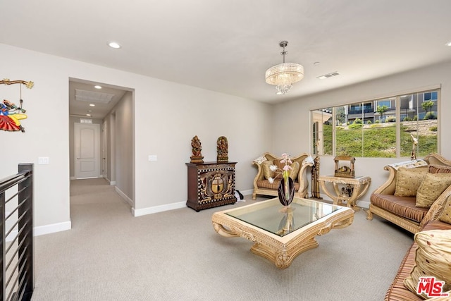 living room featuring light carpet and an inviting chandelier