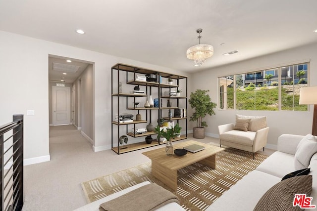 living area featuring light colored carpet and a chandelier