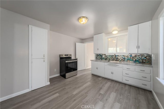 kitchen with white cabinetry, sink, light hardwood / wood-style floors, and stainless steel electric range