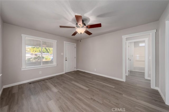 empty room featuring wood-type flooring and ceiling fan