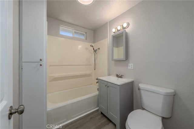 full bathroom featuring shower / washtub combination, vanity, wood-type flooring, and toilet