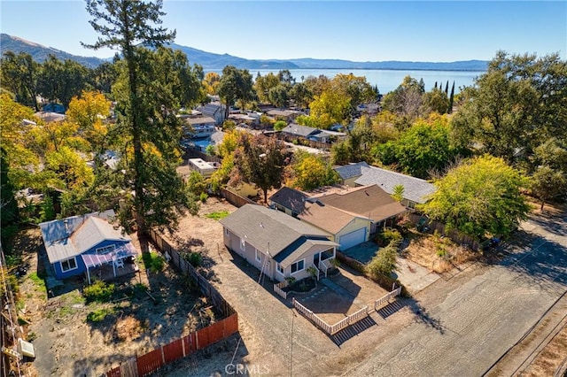 birds eye view of property with a water and mountain view