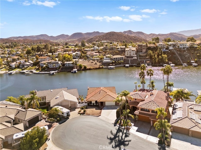 drone / aerial view with a residential view and a water and mountain view