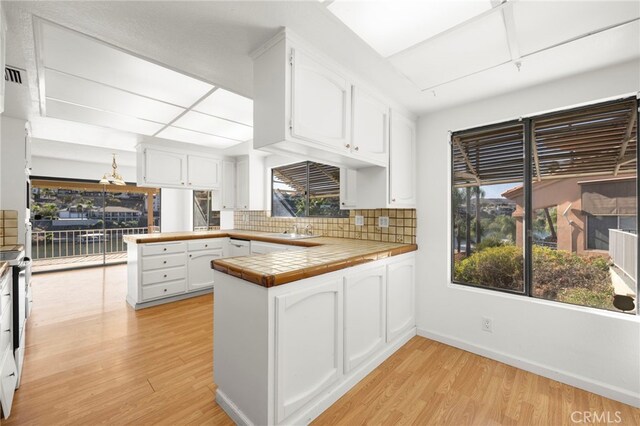 kitchen featuring white cabinetry and a peninsula