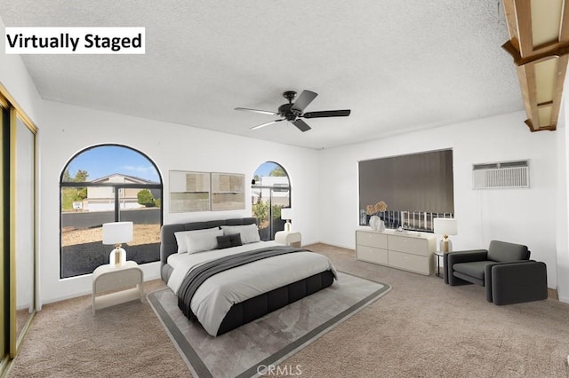 bedroom featuring a textured ceiling, carpet, and a ceiling fan