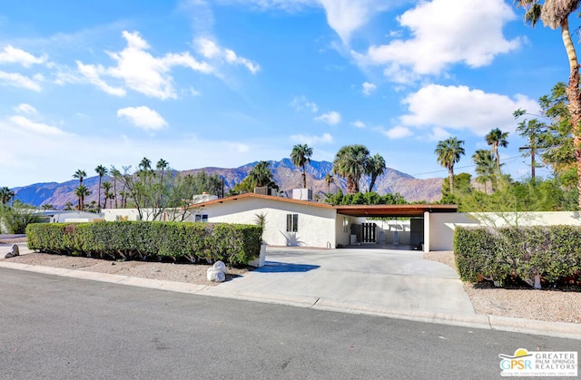 ranch-style house featuring a mountain view and a carport