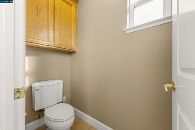 bathroom with tile patterned flooring and toilet