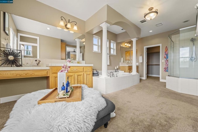 bathroom featuring shower with separate bathtub, vanity, and ornate columns