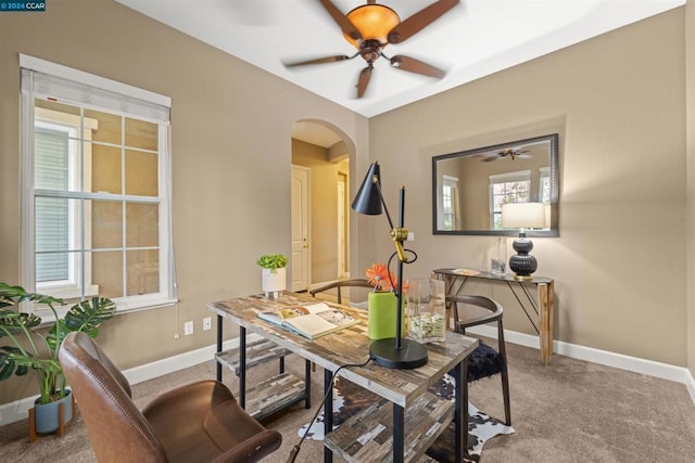 carpeted office space featuring ceiling fan