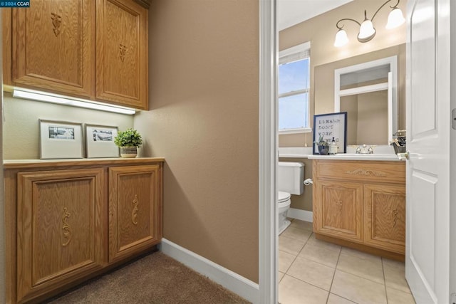 bathroom featuring tile patterned flooring, vanity, and toilet