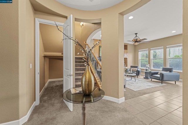 staircase featuring carpet and ceiling fan