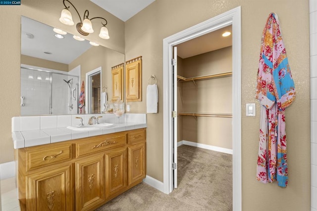 bathroom featuring vanity and a shower with shower door