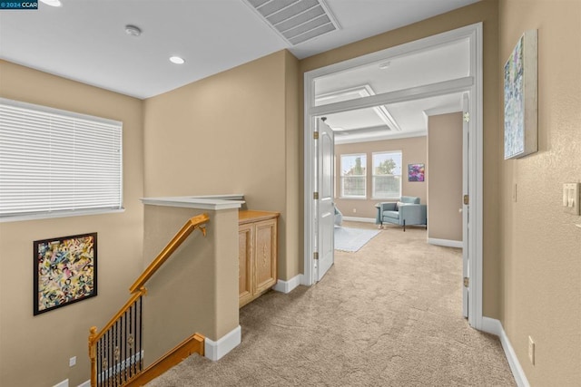 hallway with light colored carpet