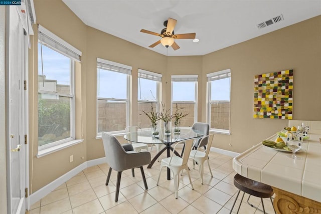 dining space with ceiling fan and light tile patterned floors