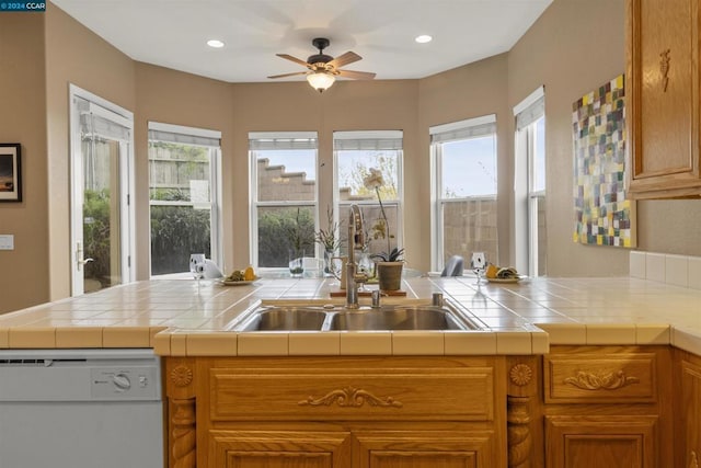 kitchen with kitchen peninsula, tile countertops, and dishwasher