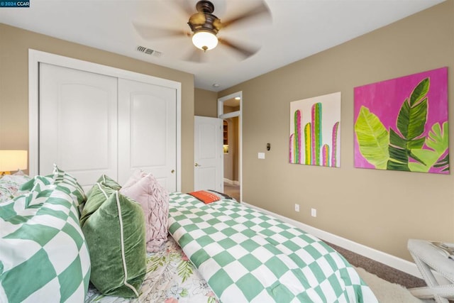 carpeted bedroom featuring a closet and ceiling fan