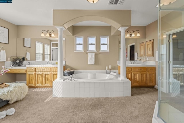 bathroom with vanity, separate shower and tub, and ornate columns