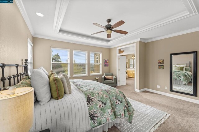 bedroom with a tray ceiling, ceiling fan, light colored carpet, and ornamental molding