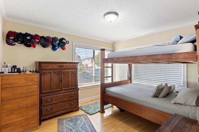 bedroom featuring light wood-type flooring and ornamental molding